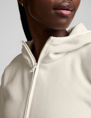 white fleece quarter zip jacket with a kangaroo pocket.