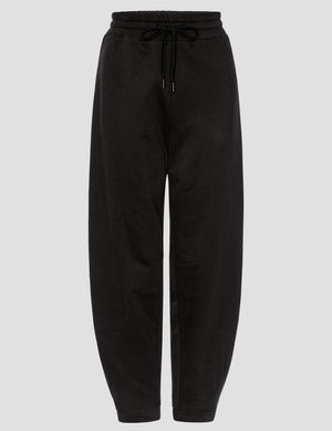 black fleece barrel style sweatpants against a plain background.